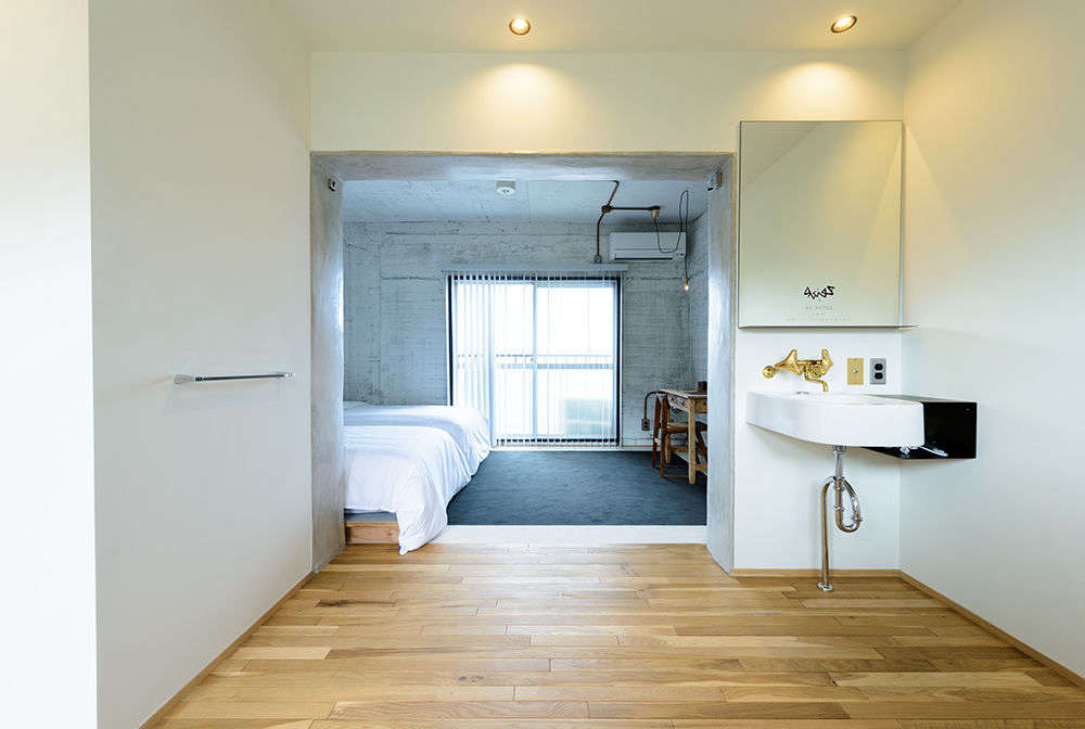 An ensuite room with a writing desk at the RC Hotel.