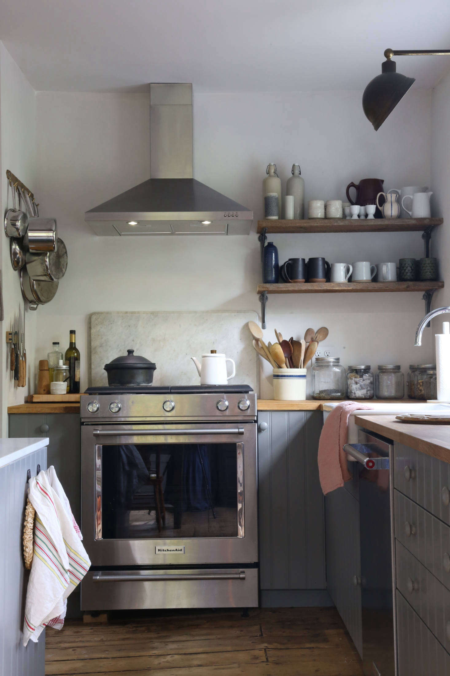 The counters are butcher block from Ikea and Amanda finished the cabinets with painted wood knobs she bought at Home Depot. The Kitchen Aid stove and other appliances are also from Home Depot: 