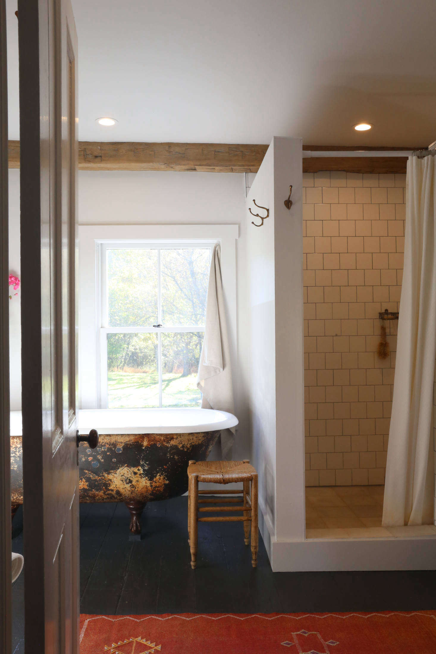 The rebuilt upstairs bath has a new-old look. The tub, along with three sinks, came from Hoffman