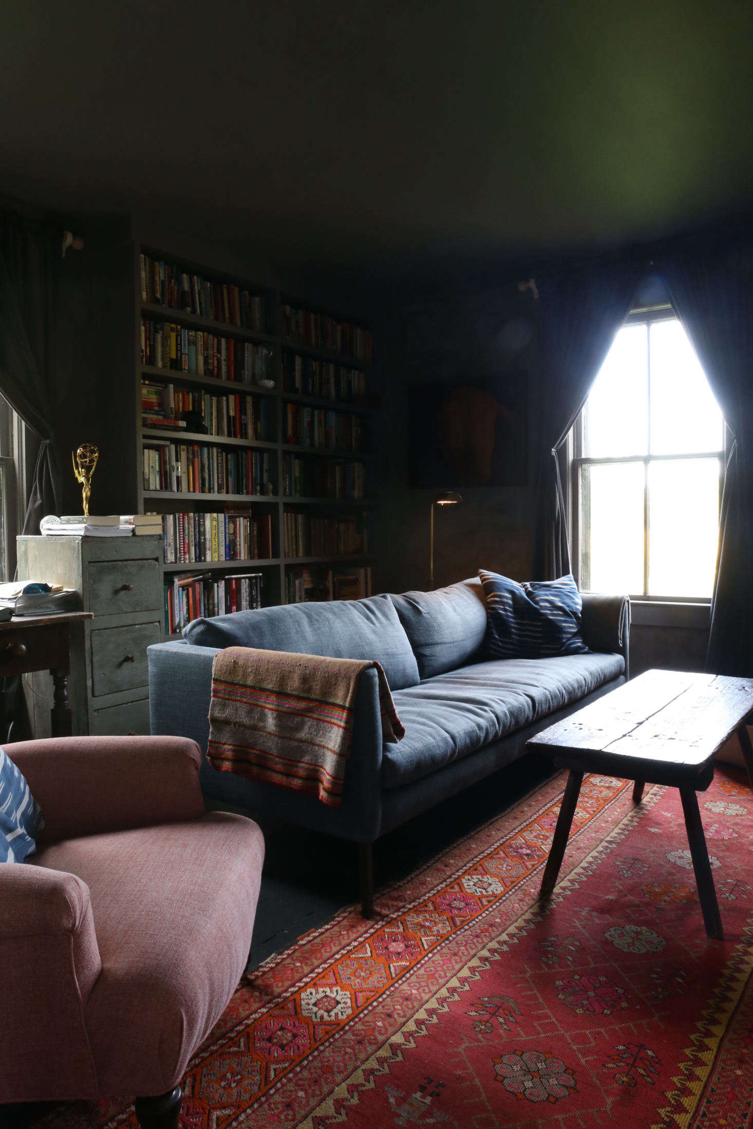 The moody back room with new built-in bookshelves is the library/TV room and Corbin