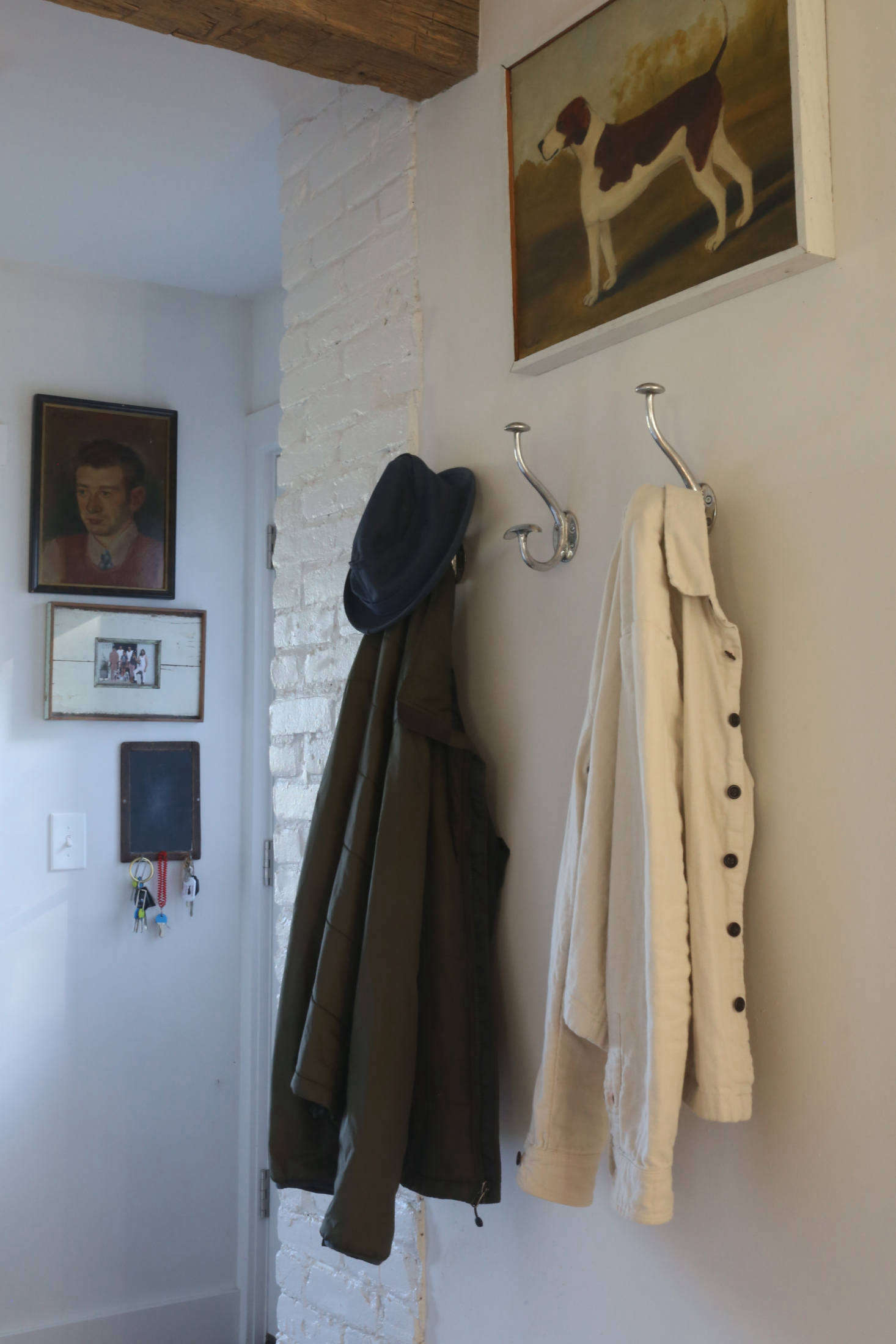 The aluminum hooks in the back entry came from a favorite hardware/antiques store in La Bisbal, Spain, within driving distance of their vacation house, A Fixed-Up Farm in the South of France—the one project they say they