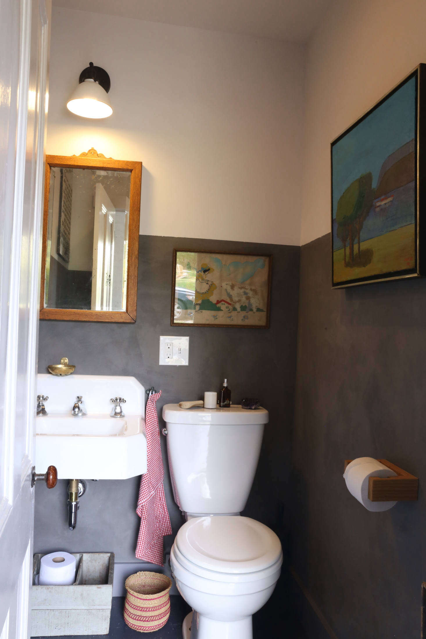 The lime-washed powder room is two-toned, another signature touch of Amanda