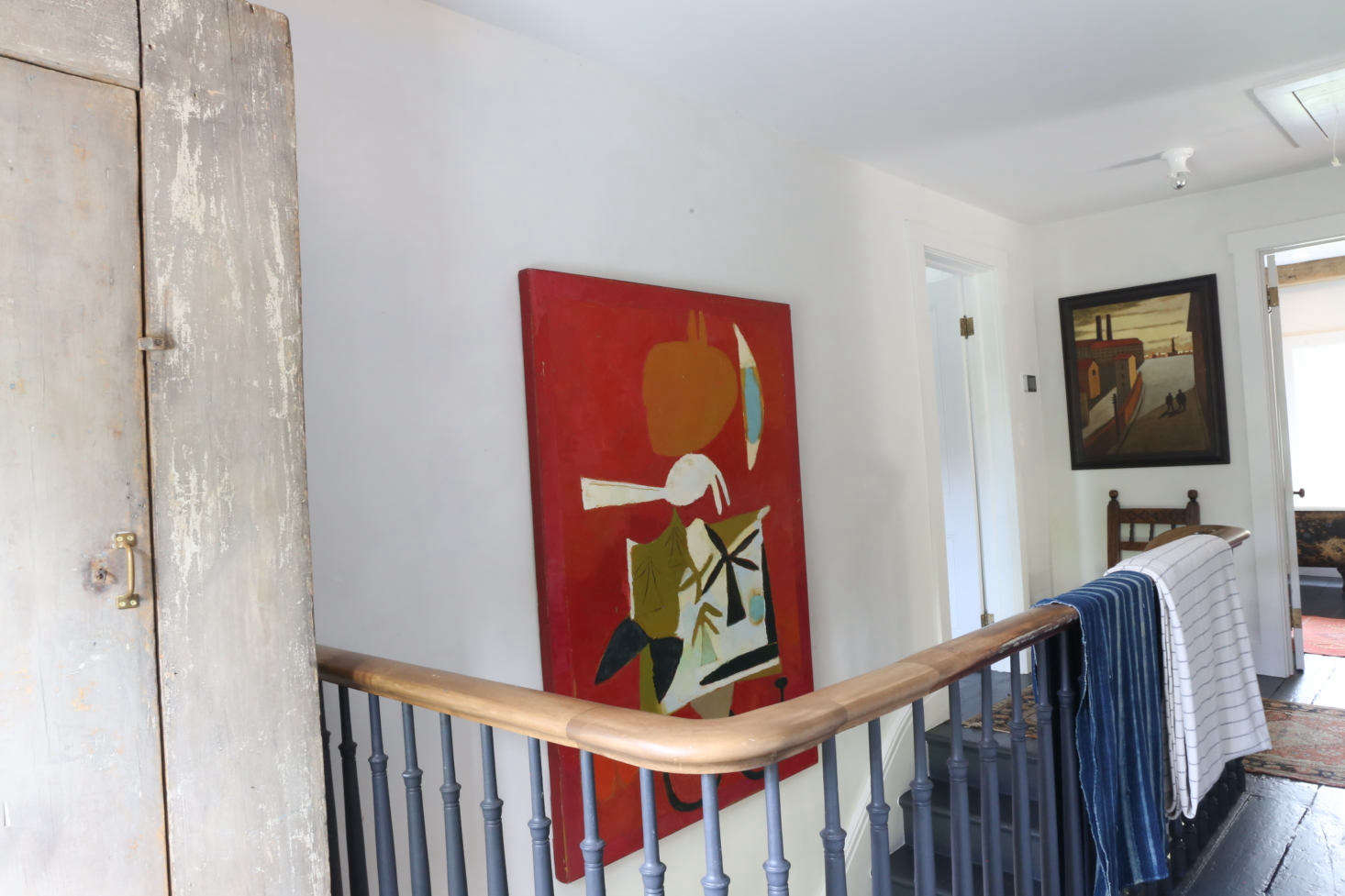 There are three bedrooms upstairs. The red painting, by Peter Aspell, is 