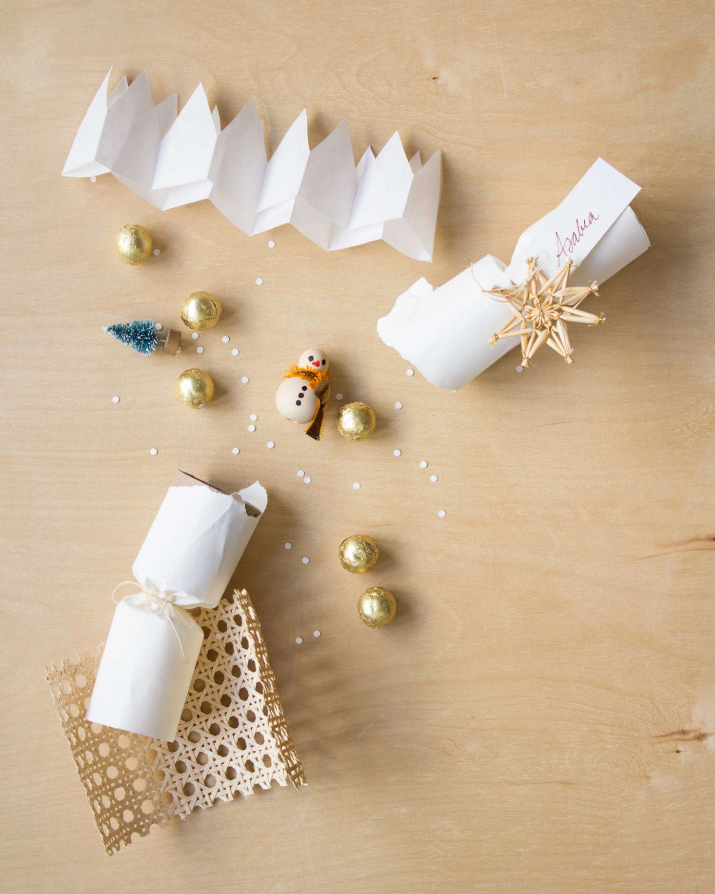 Fill each popper with small treasures. David and his team filled theirs with DIY snowmen made from hot-glued wooden beads. The eyes, nose, and buttons were drawn with markers.