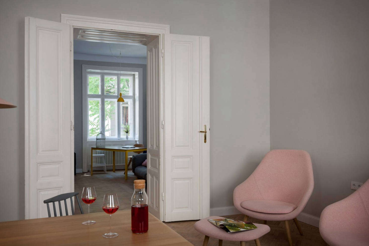 A peek into the living room through the French doors. The lounge chairs are from Hay.