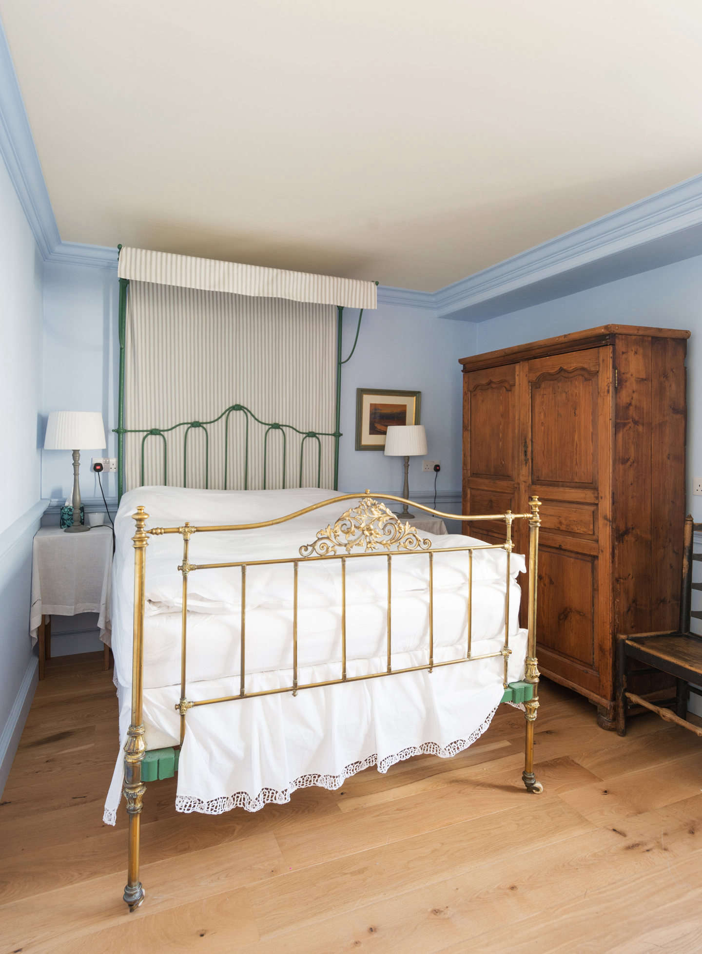 A second bedroom on the second floor has walls painted a cornflower blue.