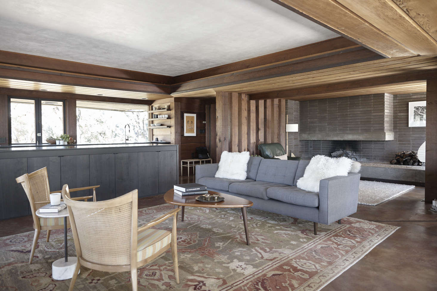 Janet found the vintage Paul McCobb sofa on Chairish and the vintage teak cane-backed Paul McCobb lounge chairs on data-src=