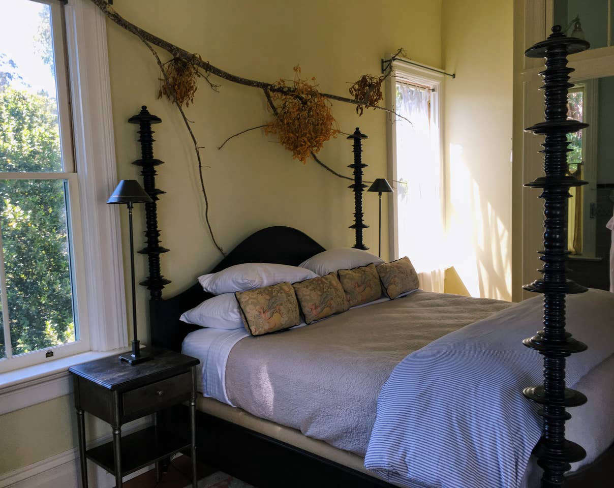 Foraged branches and foliage above the bed in the master suite.