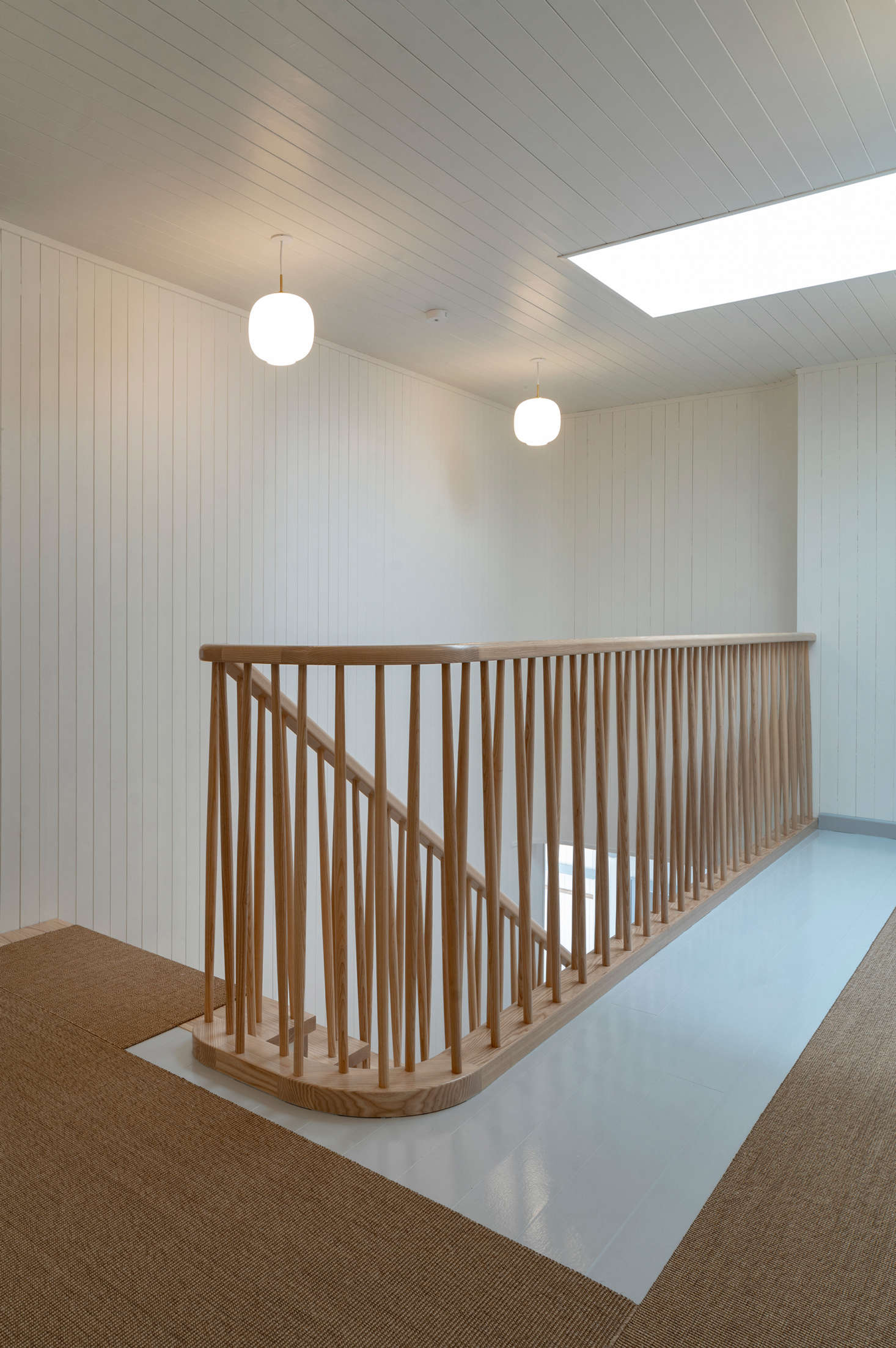 A simple sisal runner pairs perfectly with the beautifully designed stair railing.