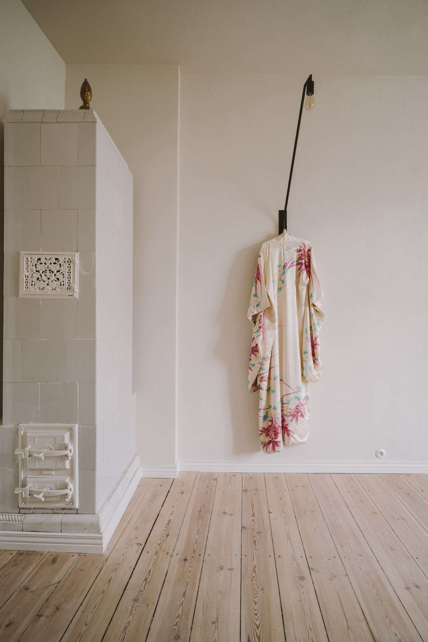 The tiled fireplace is original to the home. The light is a custom Colombe design.