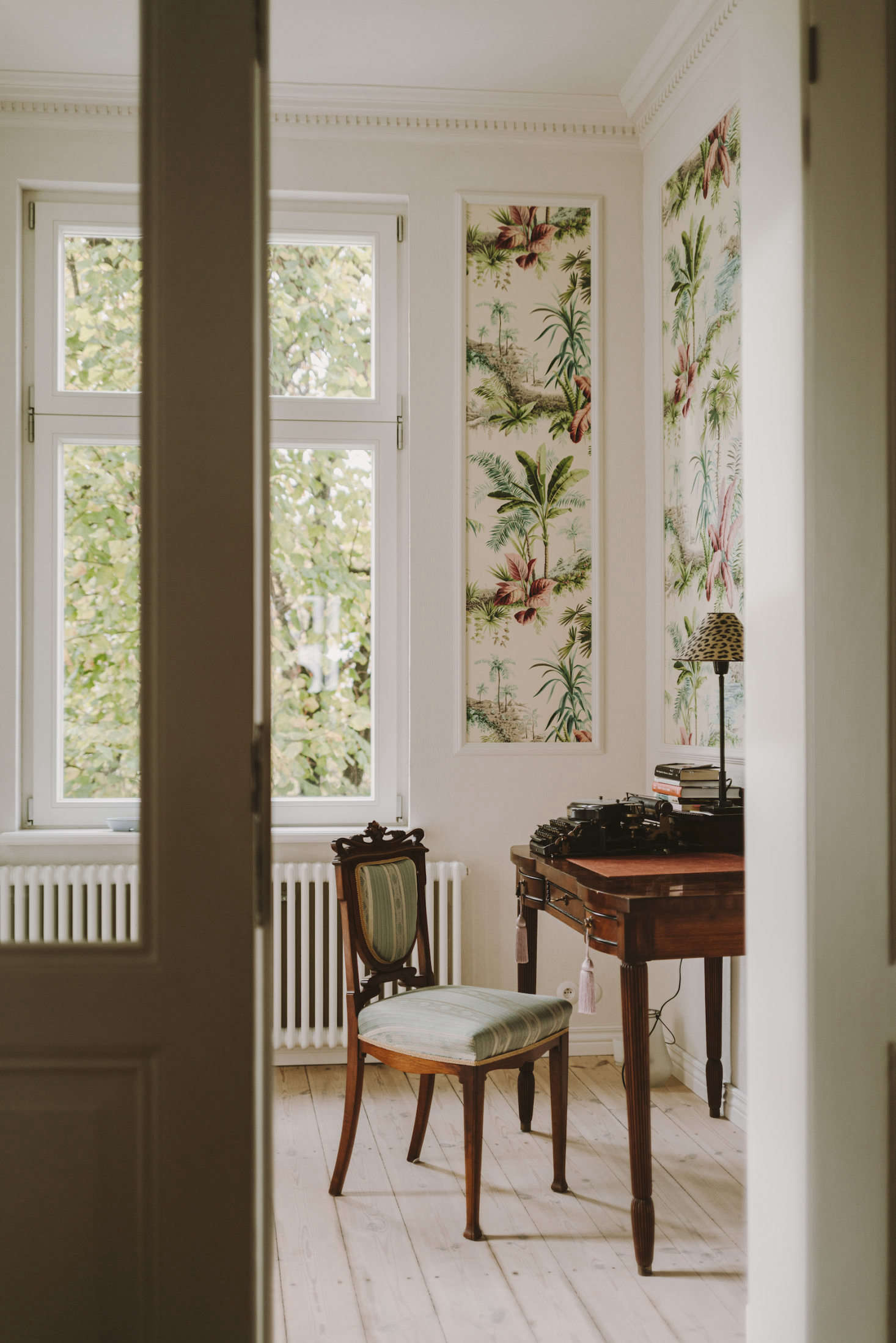 In a departure from the pale walls elsewhere in the home, the office features tropical 