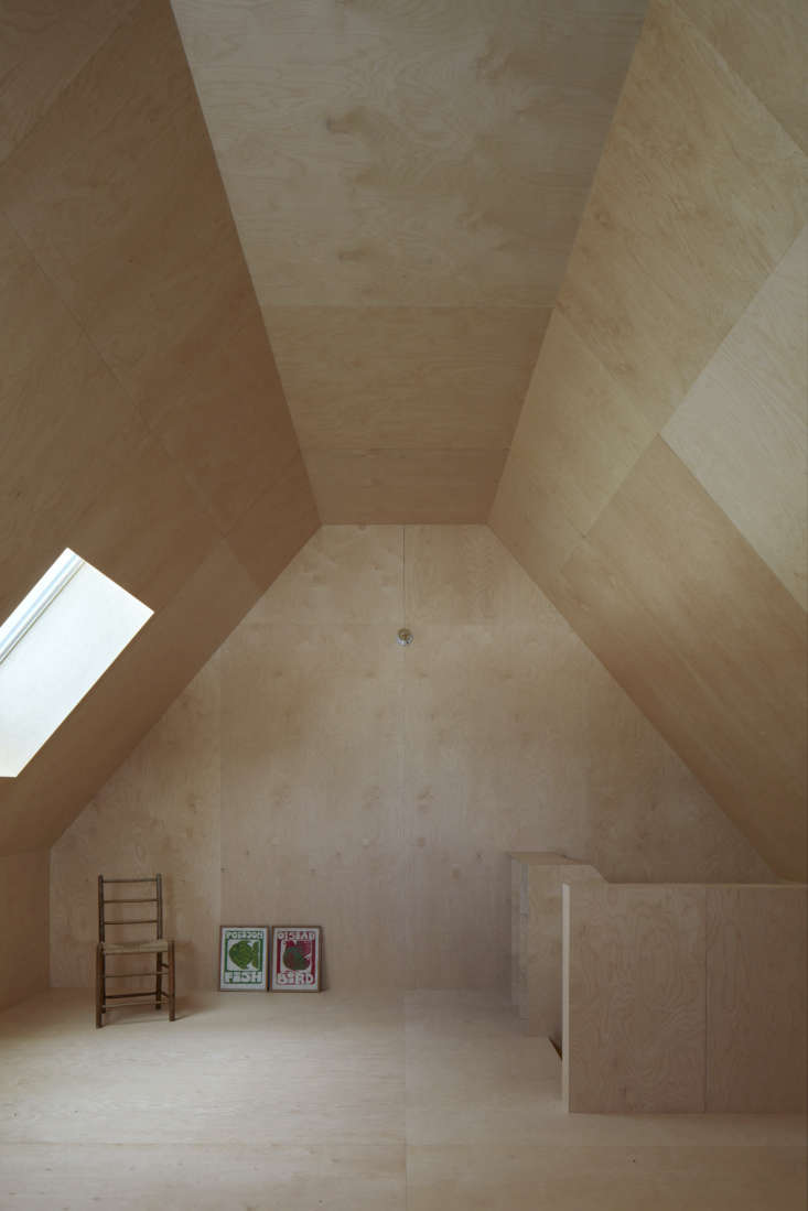 patterned by plywood squares, the room is used as a work and play space. there  30