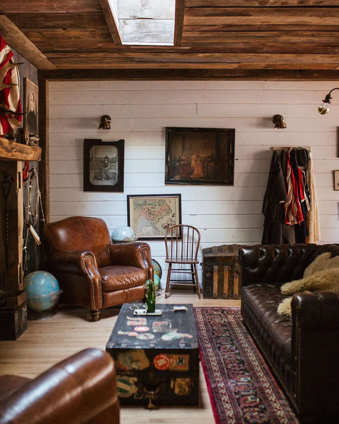 The Red Rose living room is furnished with one of several Chesterfield sofas, club chairs, and old trunks acquired on Craigslist. N.B.: Though JP