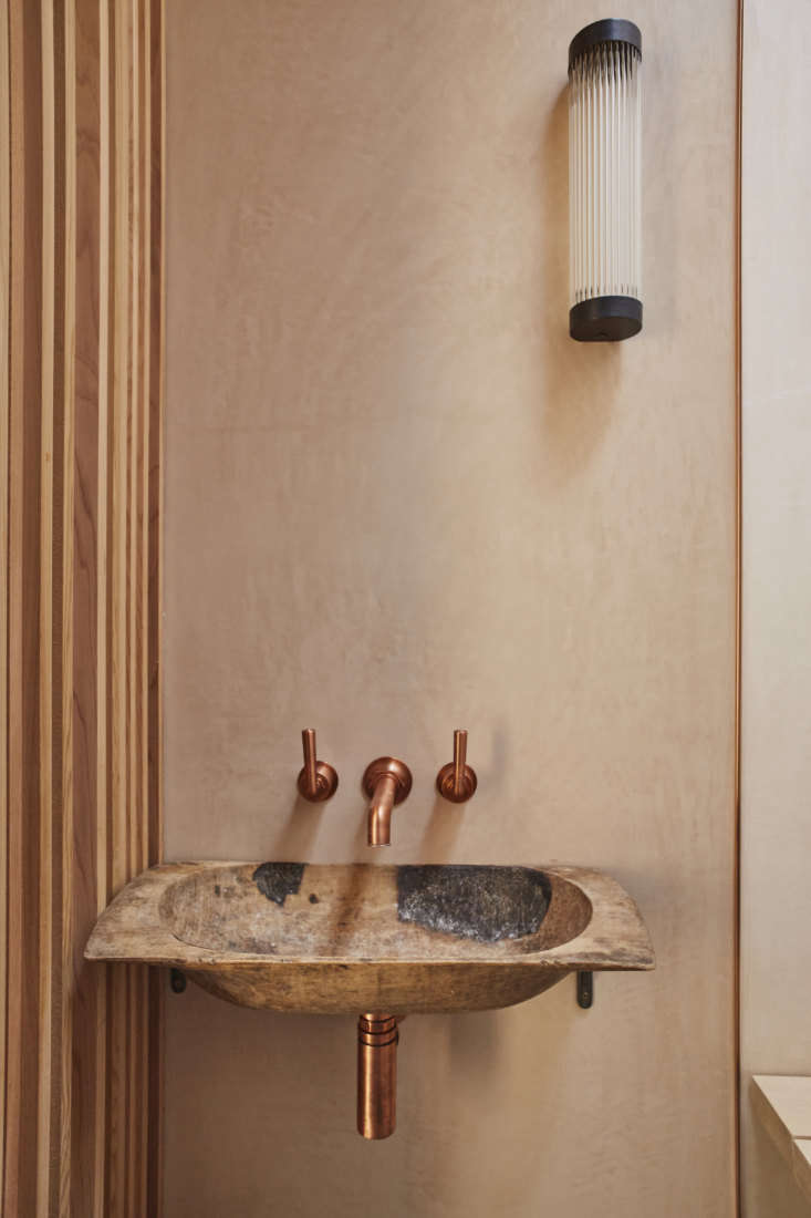 the basin is made from an old wood bread trough. the copper fixtures are from w 28