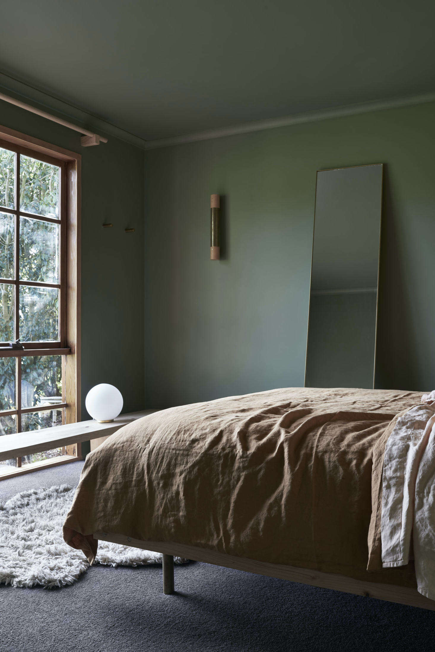 Another new window brings greenery into the bedroom. The window bench serves as a table and a seat.