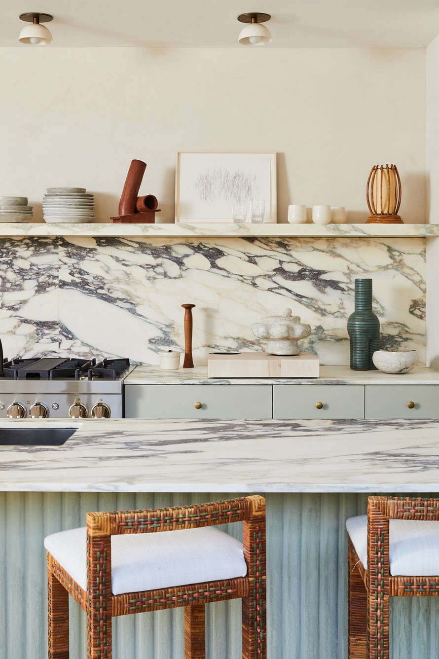Interior designer/chef Athena Calderone is especially at home in the kitchen: her Amagansett house features this marble-topped island detailed with custom plaster fluting by Kamp Studios (see below). Check out Calderone