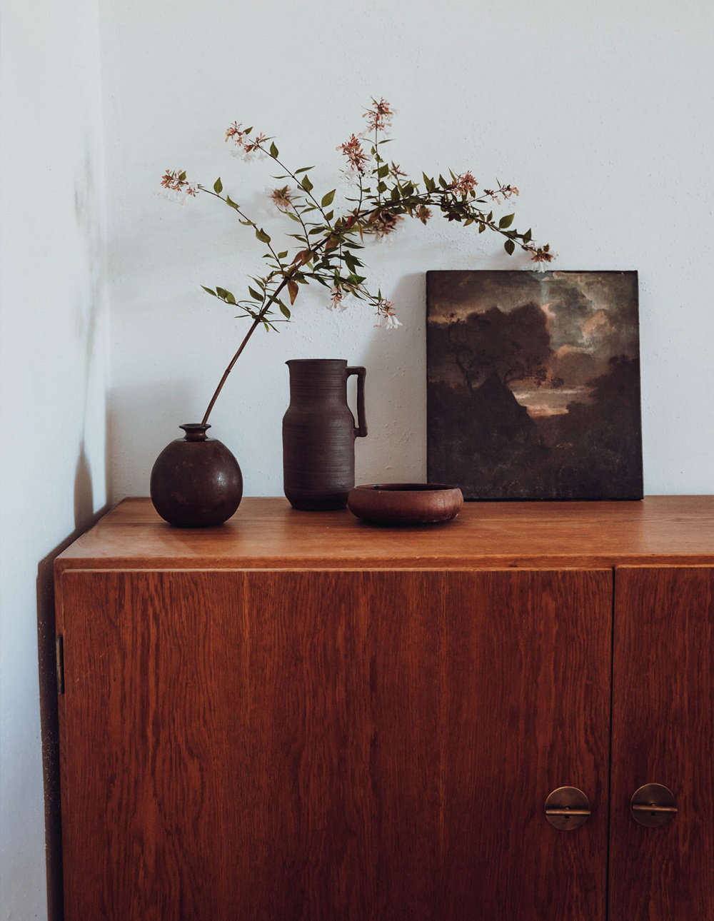 A vintage Danish cabinet in a bedroom.