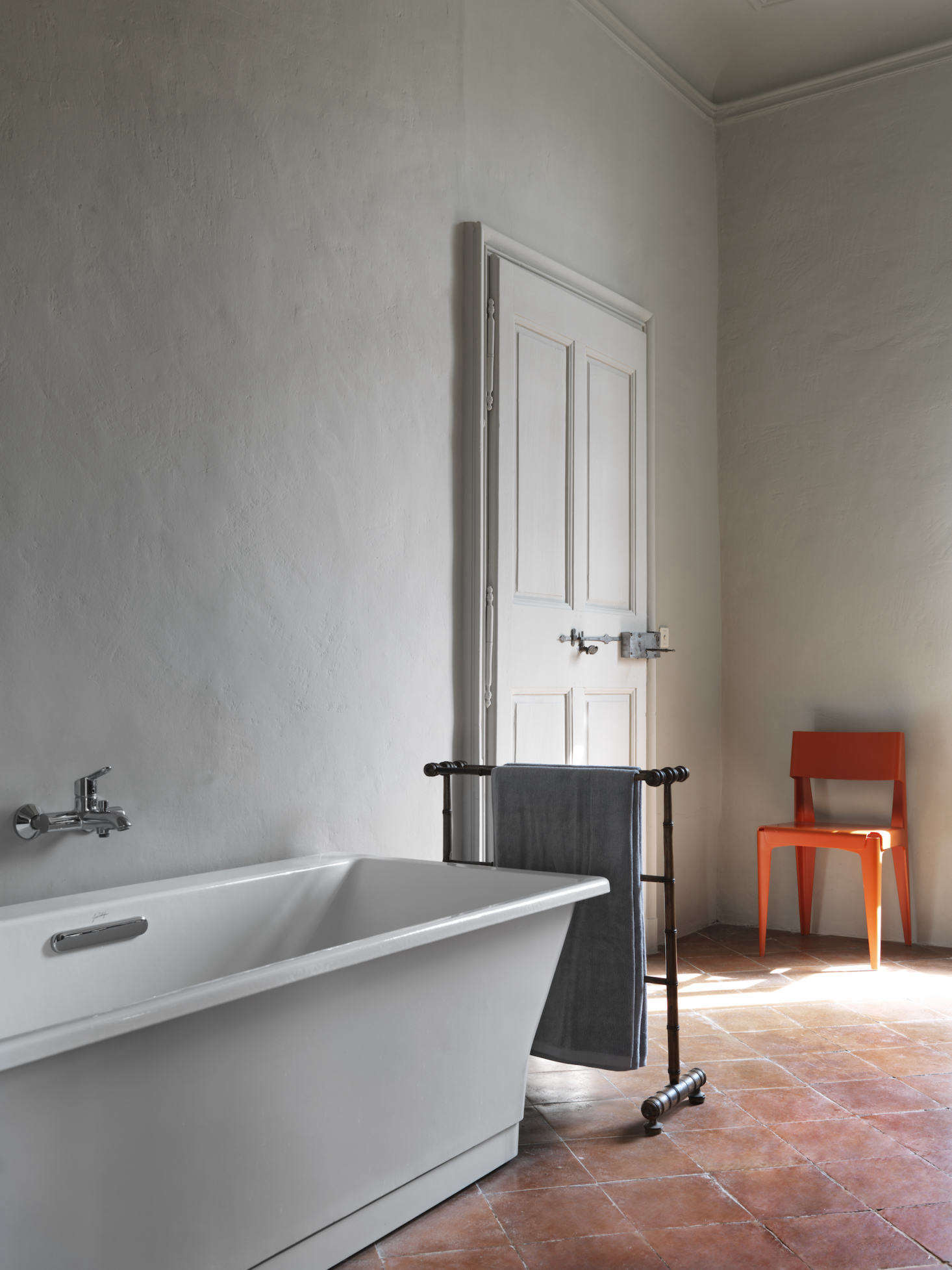 The bathtub is from Jacob Delafon in Paris; the plywood chair is by Barber & Osgerby for Isokon Plus.