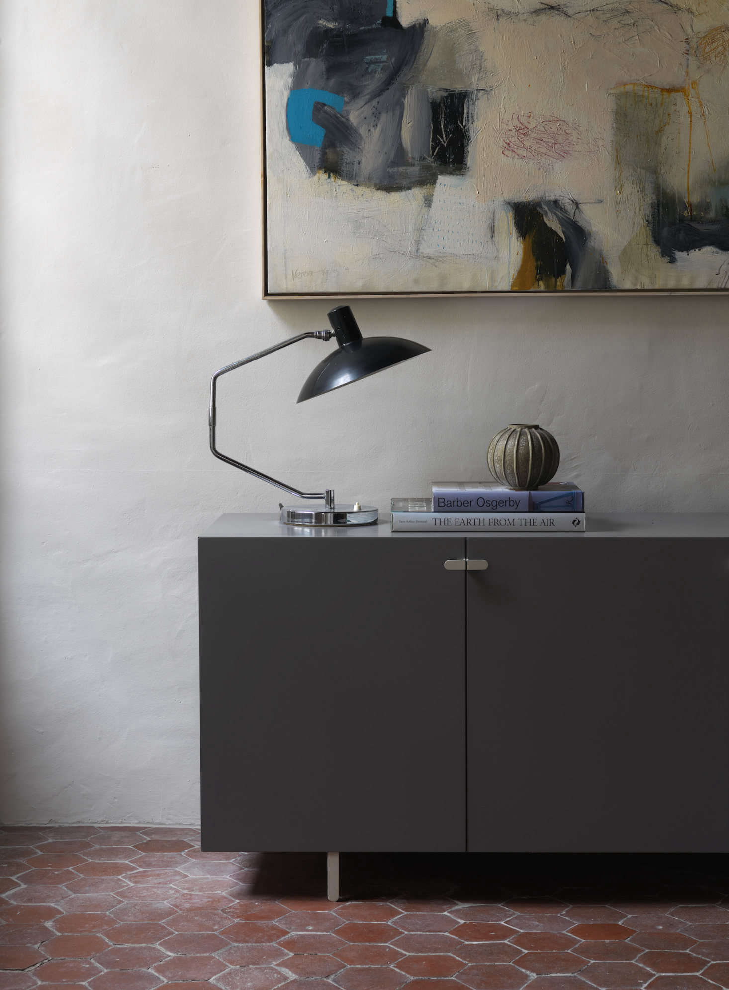 A lamp from Knoll by Clay Mitcie sits on a cabinet from Isokon Plus.