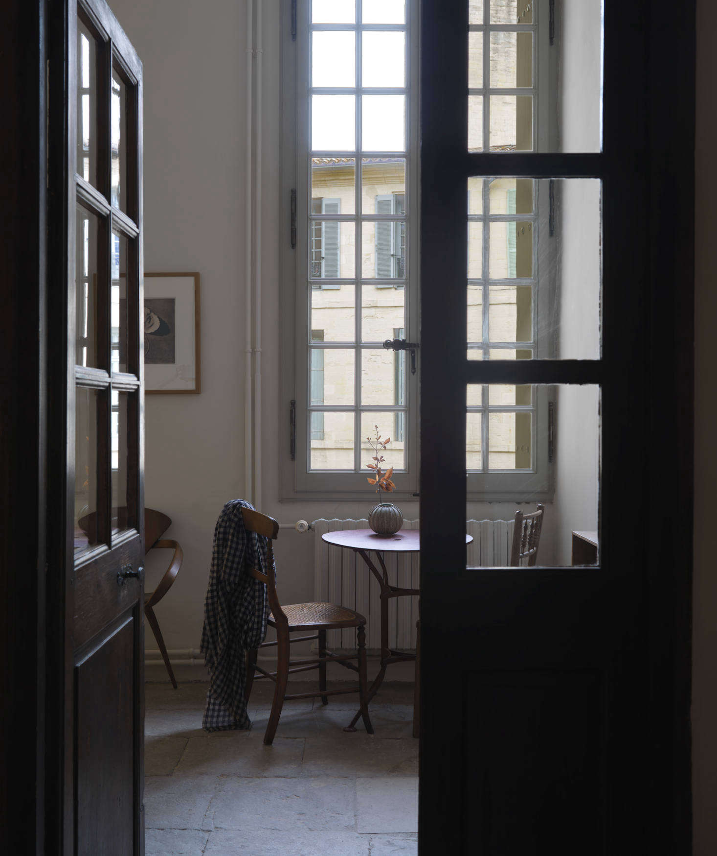 A peek into a quiet corner, anchored by a French garden table, in the office.