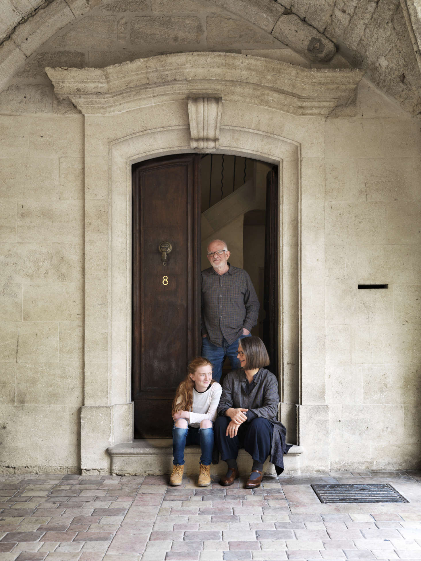 Lone and Chris McCarter with their granddaughter, Lily, on the front step of their home.