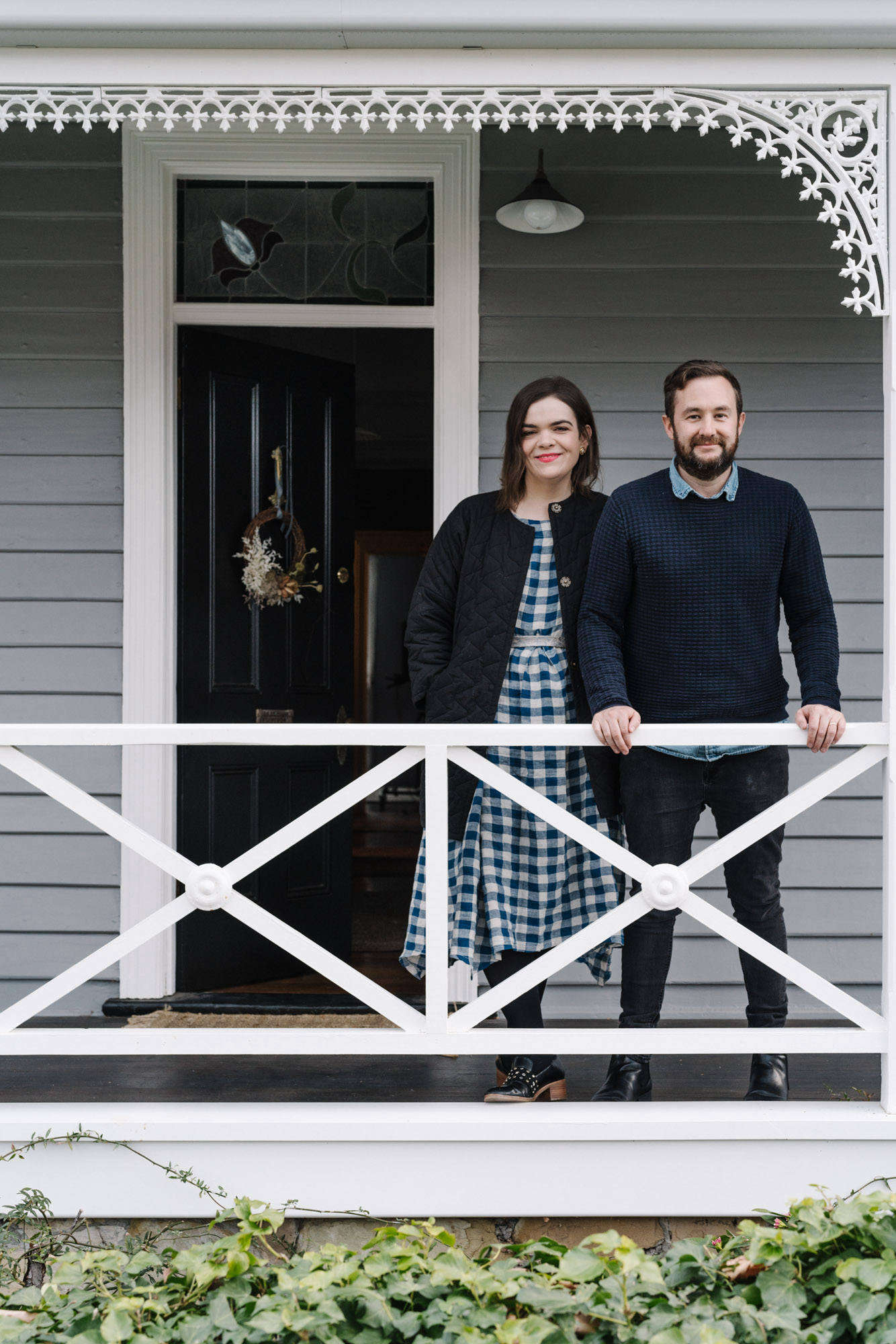 The couple on the front porch of their home.