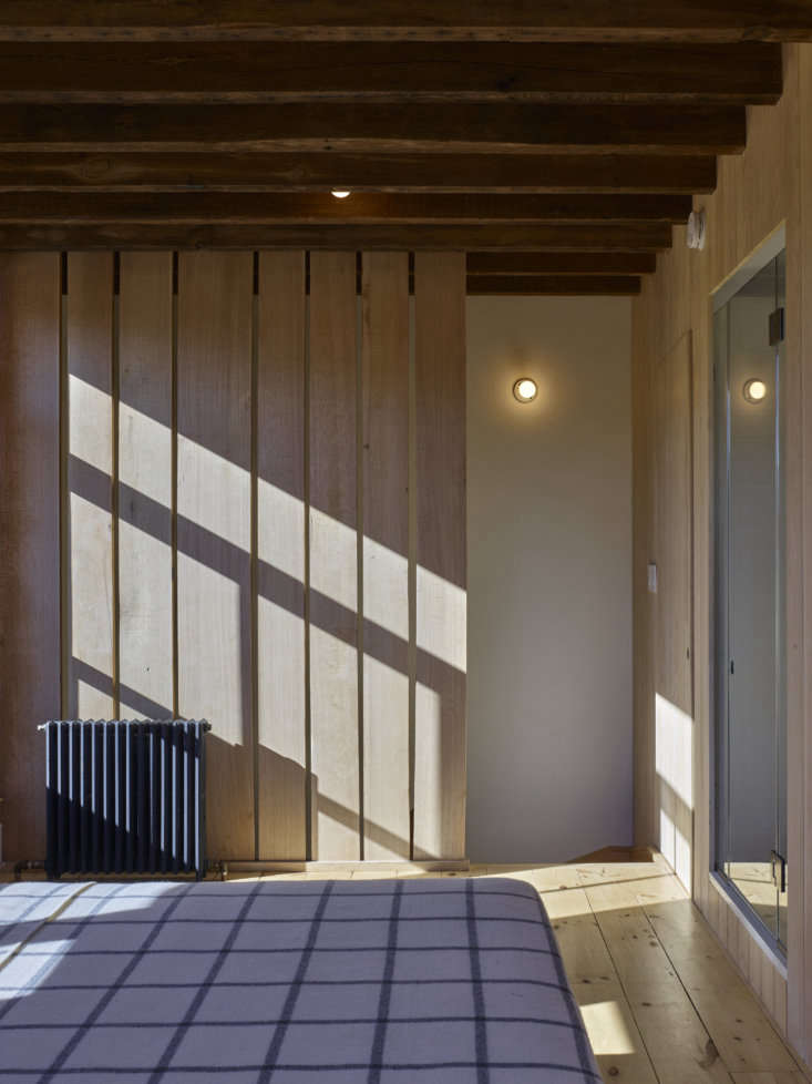 a partition of rough edged red oak sections off the stair while allowing light  38