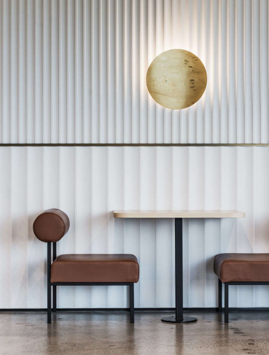 Wide and narrow fluting runs up the walls of the in-house café at tech company NCR