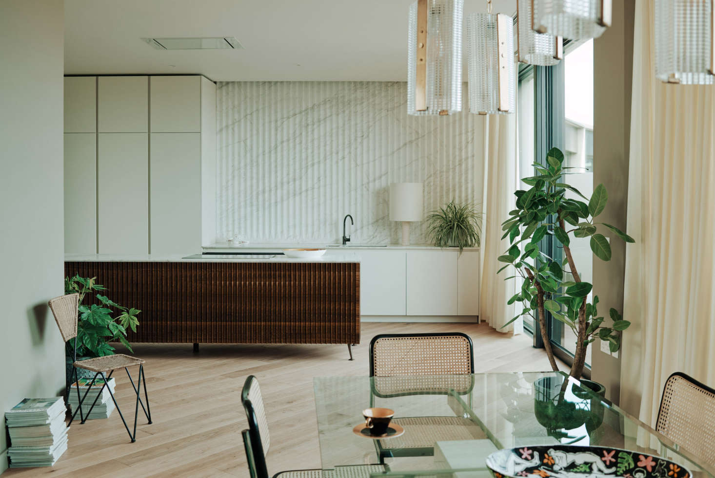 The ripple effect in walnut and marble at the Television Centre penthouse in London. Piercy & Co. architects oversaw the renovation, and fashion designer Bella Freud and interior designer Maria Speake of Retrouvious collaborated on the interiors. To see the full project, go to Retro Maximalism.