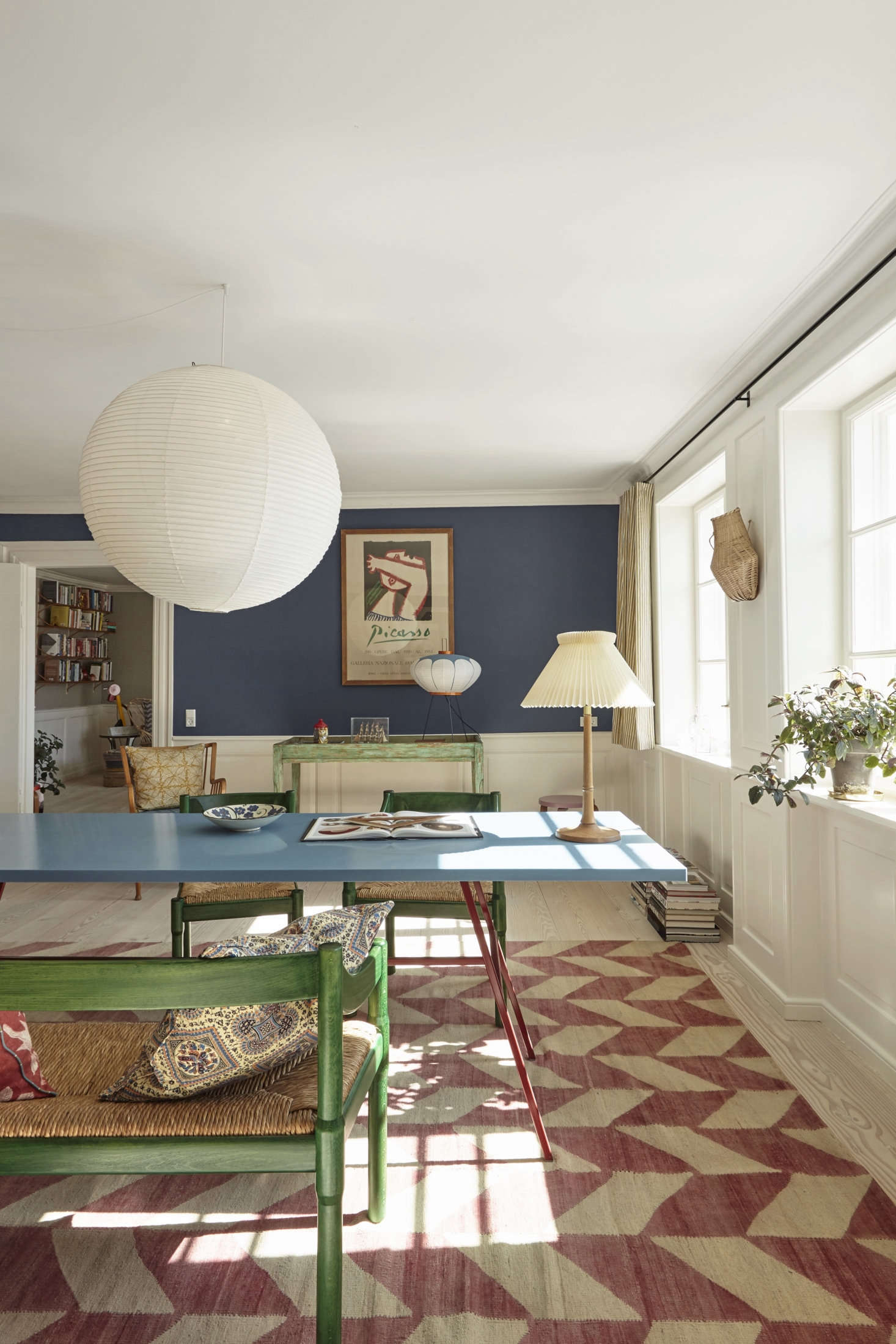 The blue on the walls is Farrow & Ball Drawing Room Blue. The dining chairs are a Vico Magistretti design from 59.