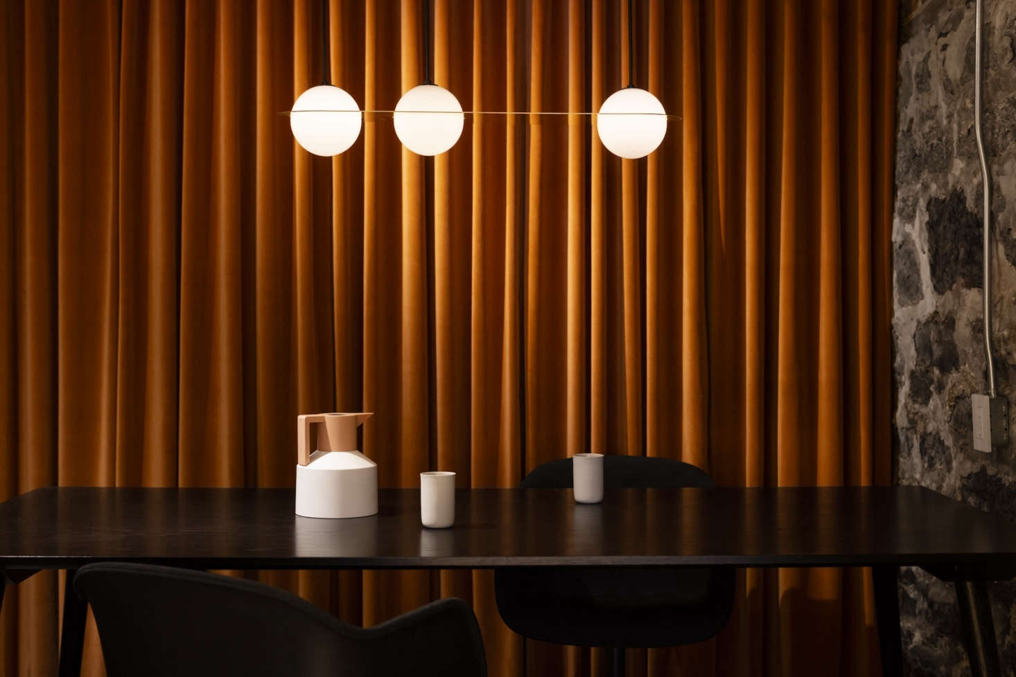 On the other end of the floor is a conference room for visiting clients. Michael added orange velvet drapery for a 