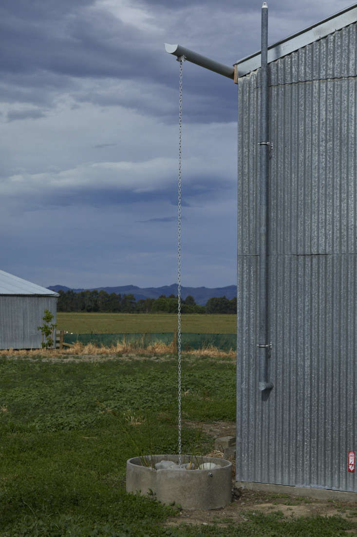 a rain chain directs water into an old concrete feeding tray originally for she 31