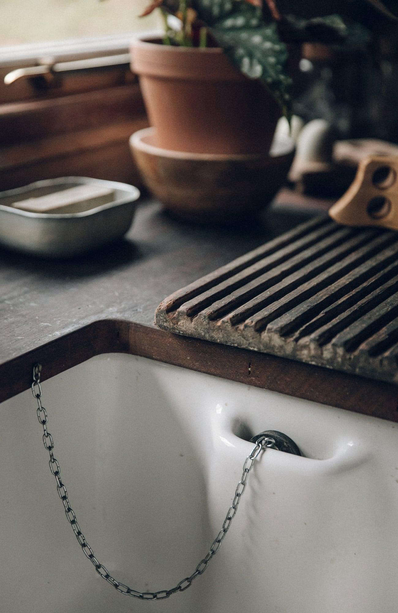 The early 00s ceramic sink is detailed with a stopper pocket.