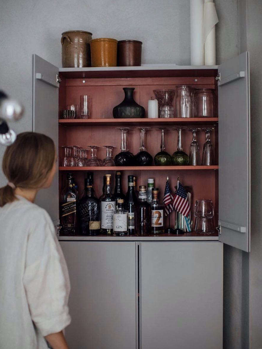 open, the cabinet becomes a wall mounted bar with a surprising backdrop. the in 23