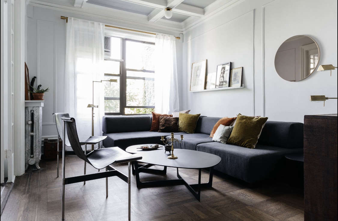 Delia mixes new and vintage pieces in the living room. A West Elm sectional plays nice with two vintage leather chairs handed down from the client