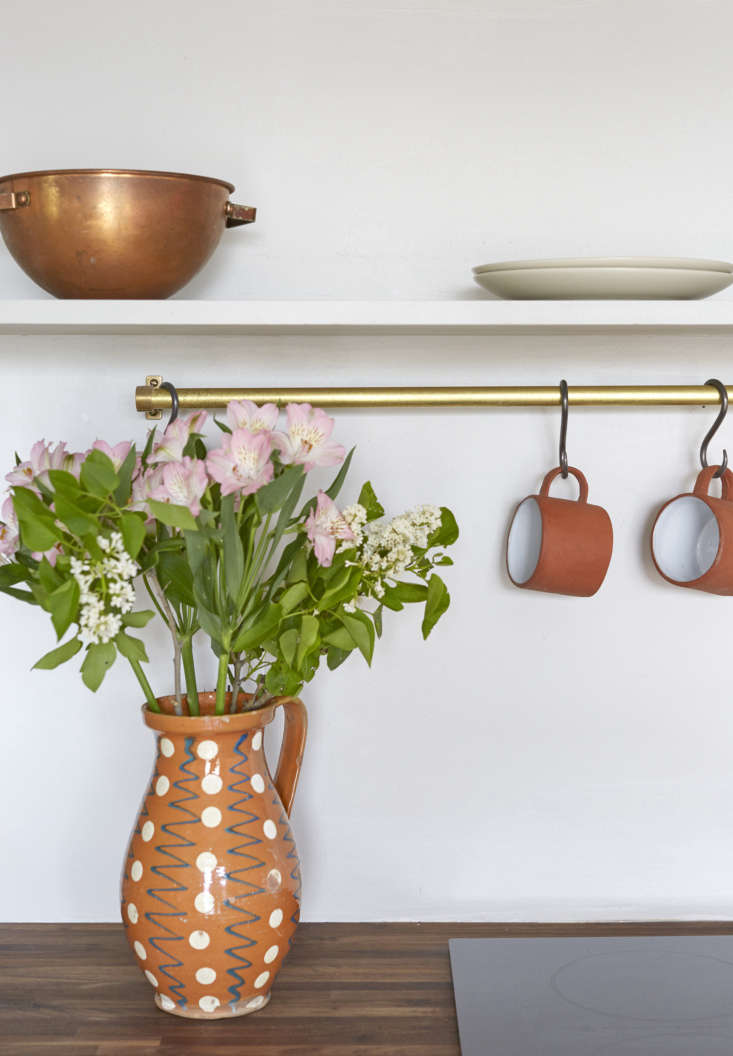 mugs hang on s hooks from a brass rail. see more in trend alert: \13 kitchens w 21