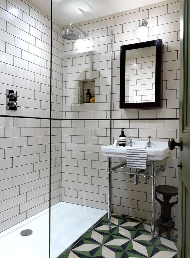 in the tiny bath, lonika installed a glass walled shower with metro tiles on th 27