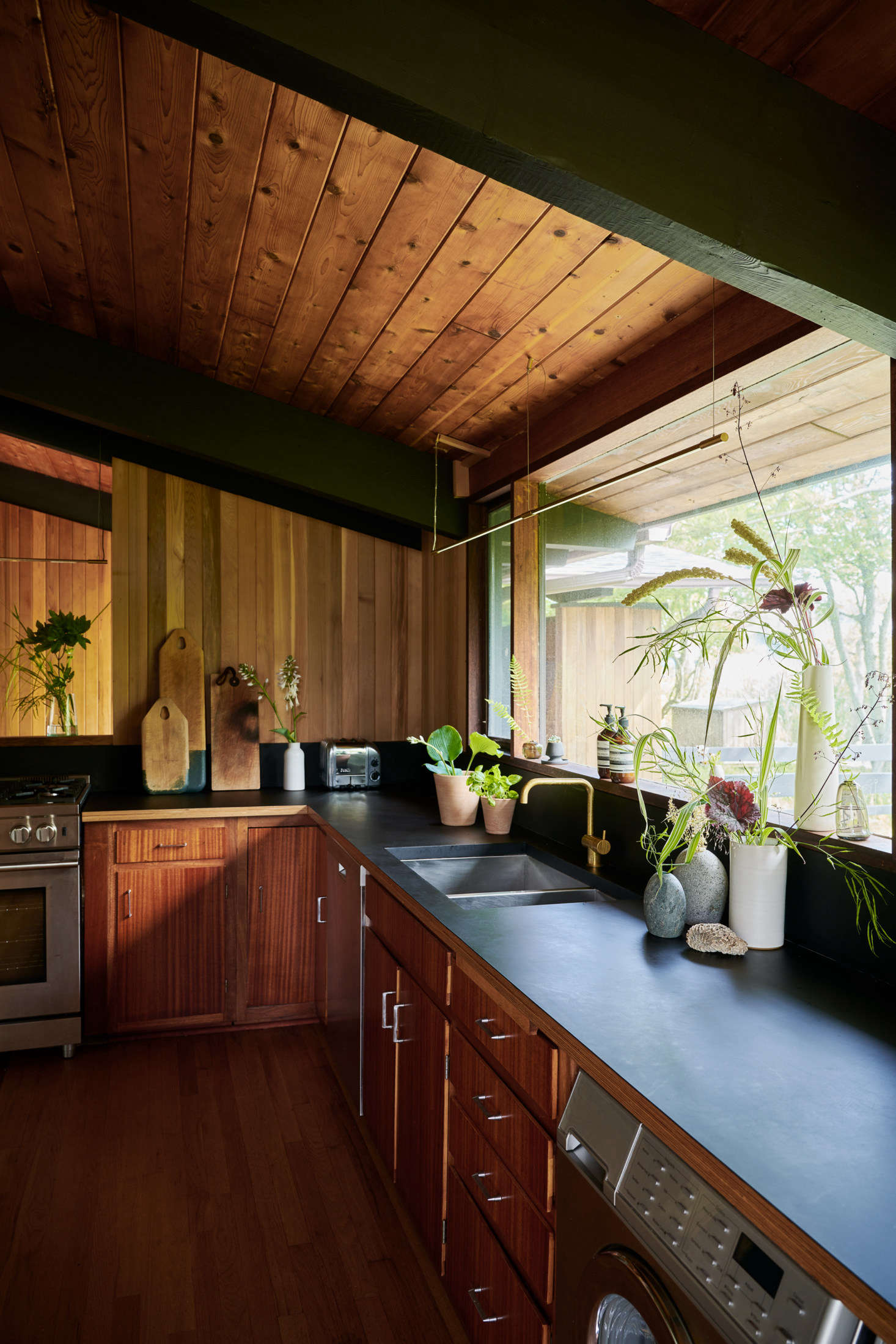 The kitchen can become a mini greenhouse, filled with botanicals of all kinds. On the counter are stems from Bloomist’s dried and EcoFaux collections, including airy Dried Pepper Grass ($) and dark EcoFaux Chocolate Cosmos ($ per stem).