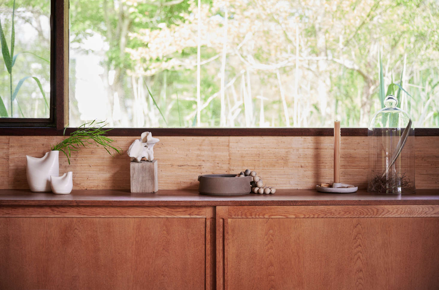 A simple vignette on a sideboard: a string of Tunisian Clay Beads ($98); a Stoneware Candlestick Holder ($68), made in Illinois; and a single beeswax candle. (We like the Beeswax Column Candles, $33 a pair, hand-poured in the Catskills.)