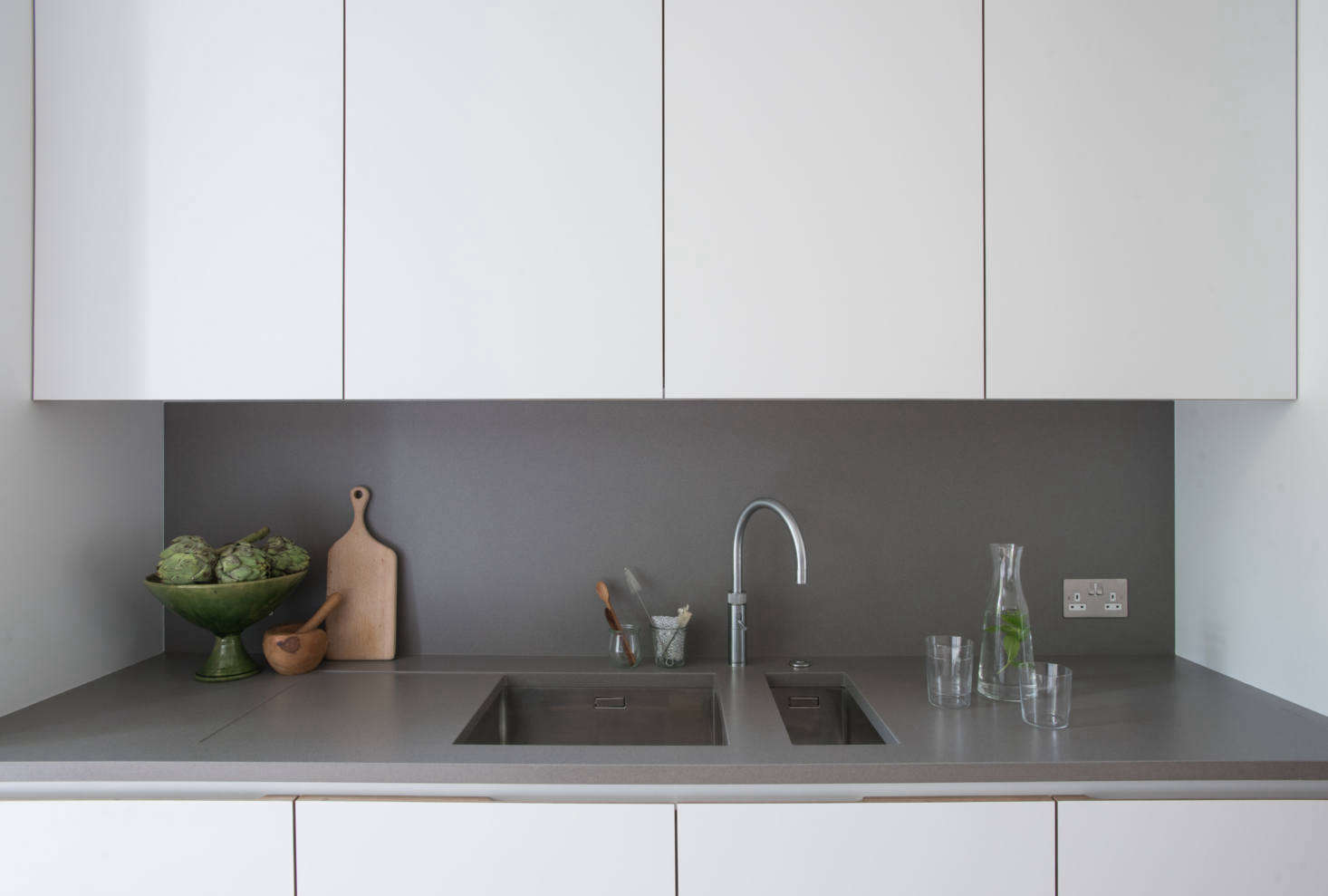 The cabinets are detailed with birch plywood pulls and interiors. Jack notes that the cabinets on this side were designed 