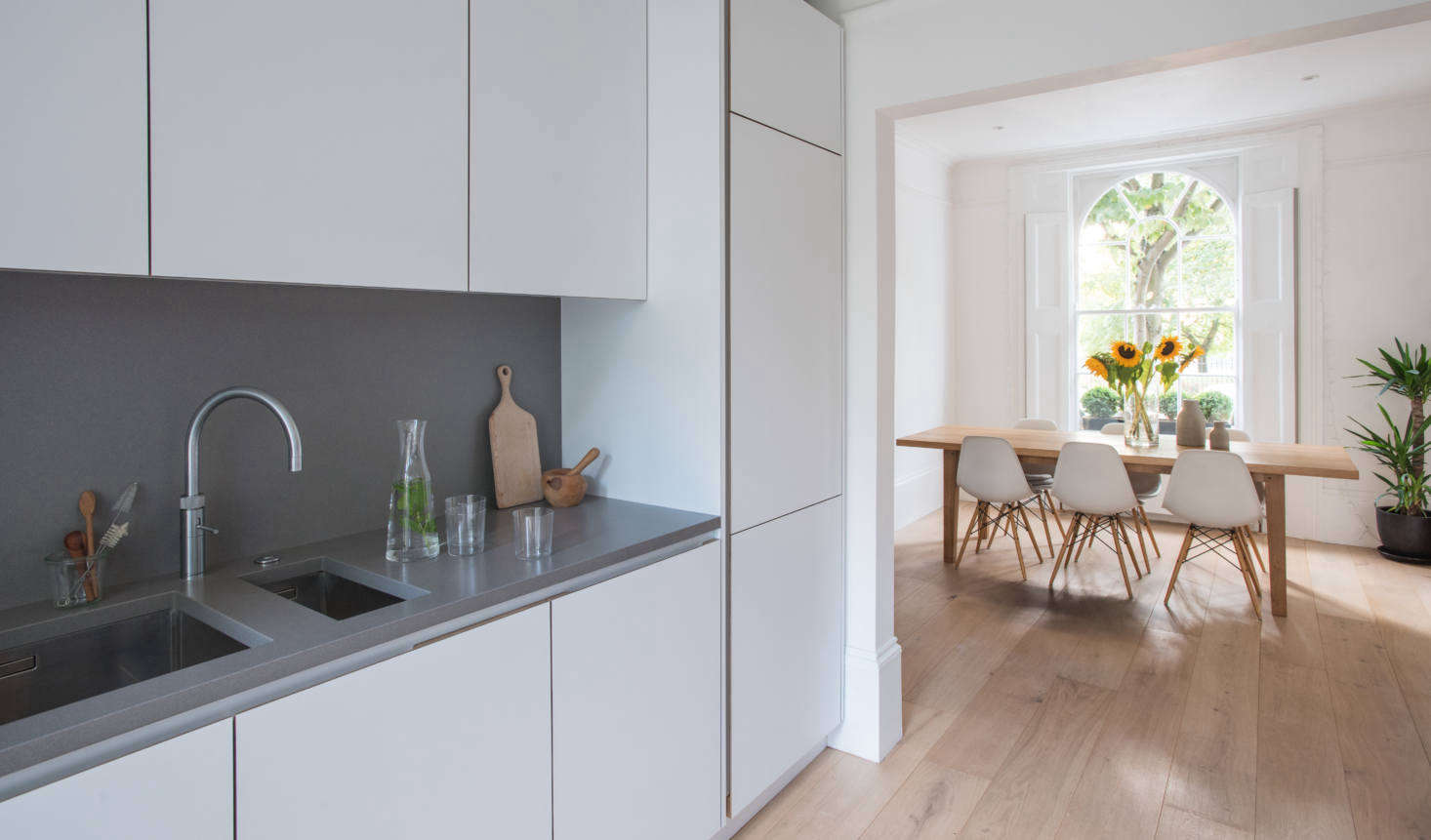 The room opens to the dining area painted Farrow & Ball