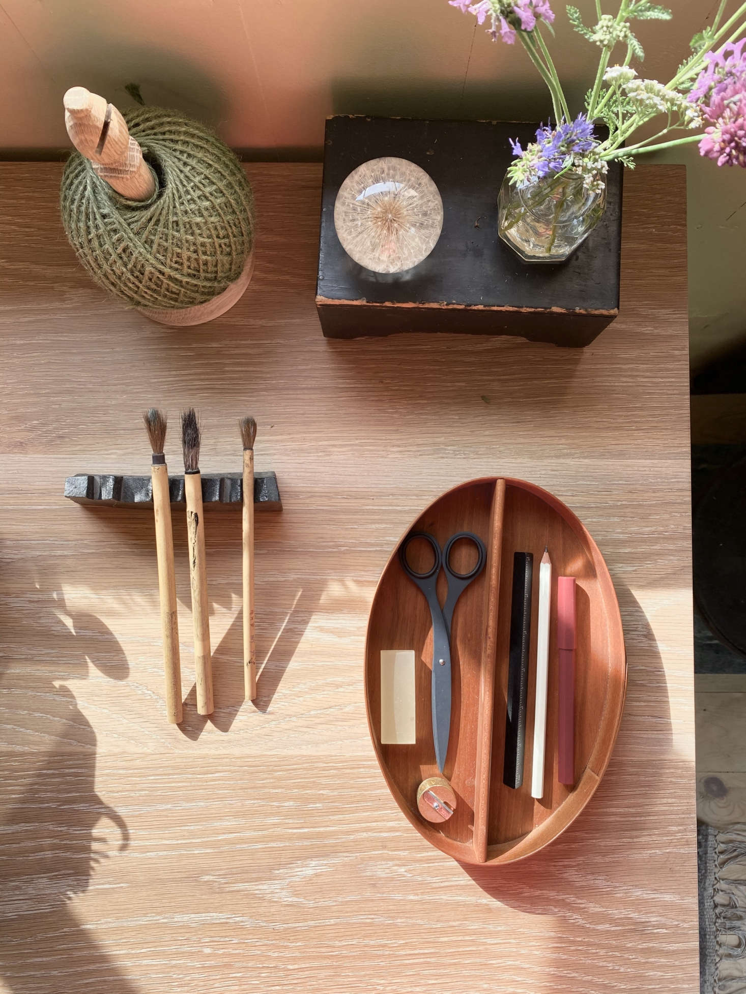 A Shaker caddy serves as a tidy desk organizer. The Oak Twine Stand is by Nutscene.