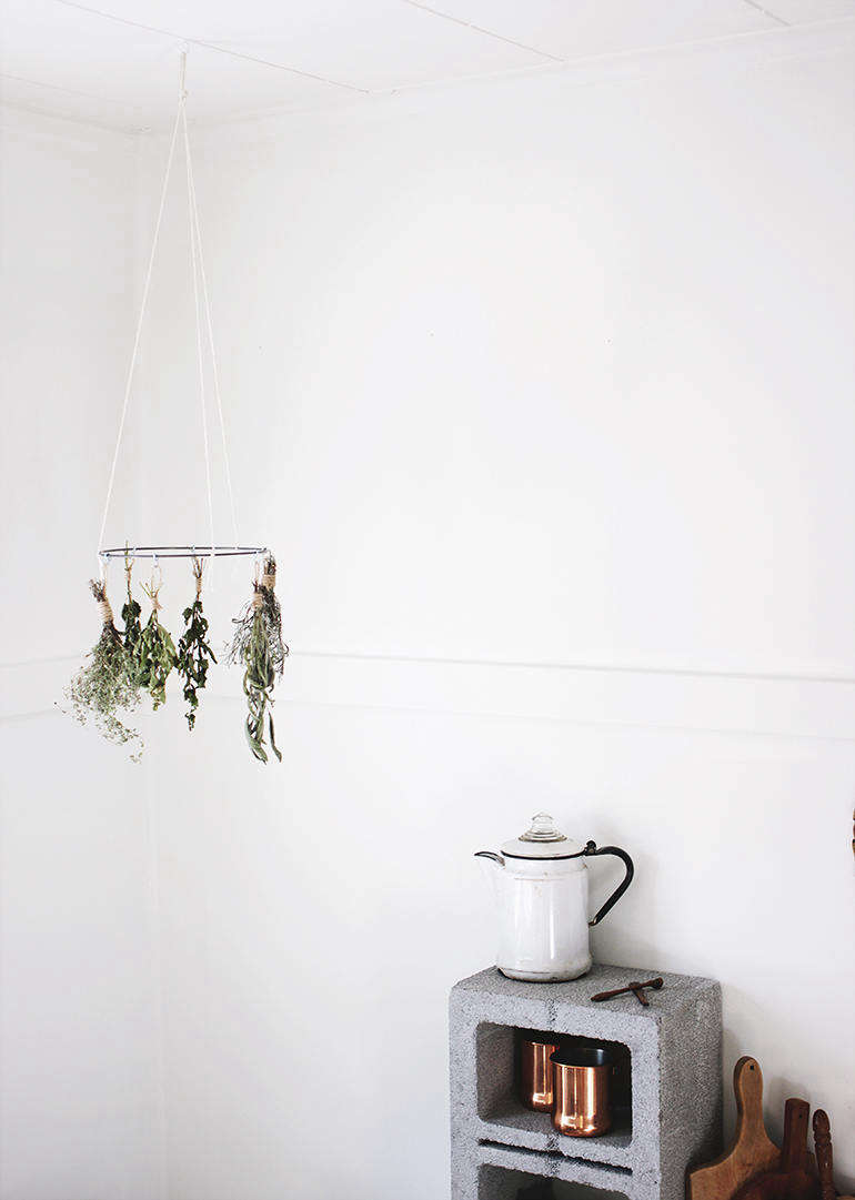 Make your own dried herbs using this DIY Herb Drying Rack. Caitlin put this one together using a hoop from a crafts store, but you can make own from a wire clothes hanger. Sage, rosemary, lavender, and lemon balm are some of the herbs she recommends for air drying.