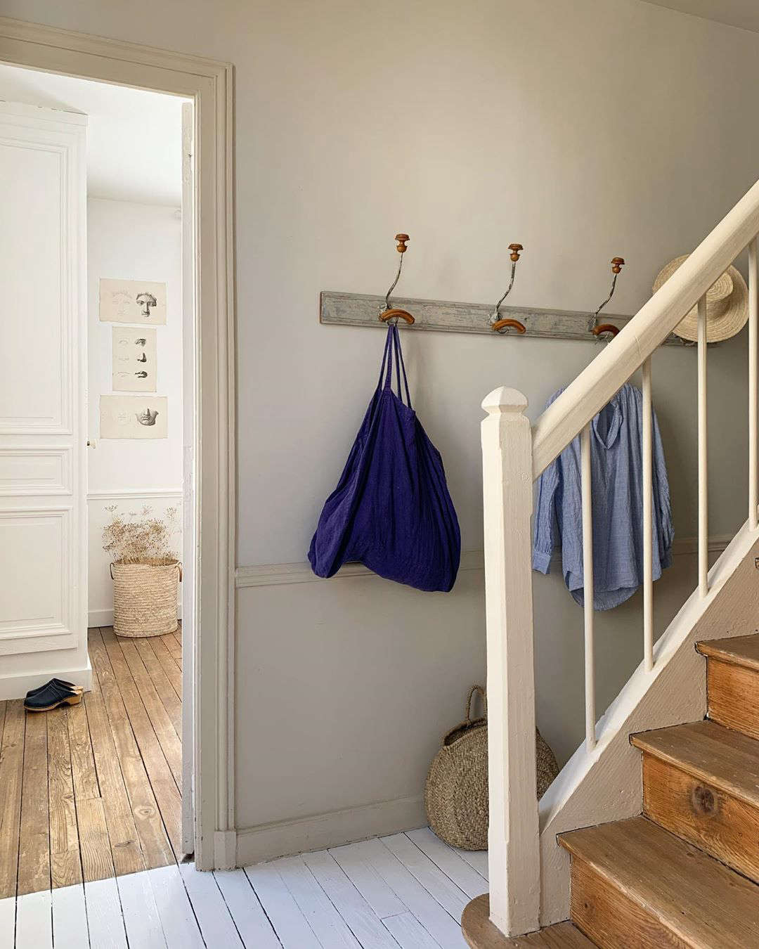 White-painted floors set a pared-back hallway apart from the rest of the house.