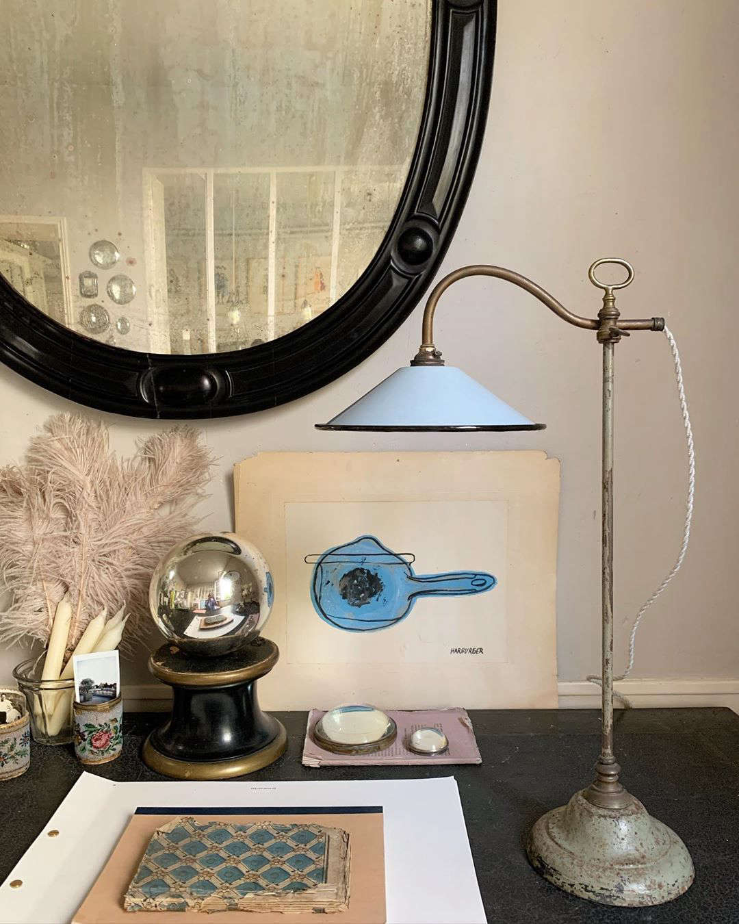 A collection of objets on a desk. (The periwinkle adjustable lamp is currently for sale.)