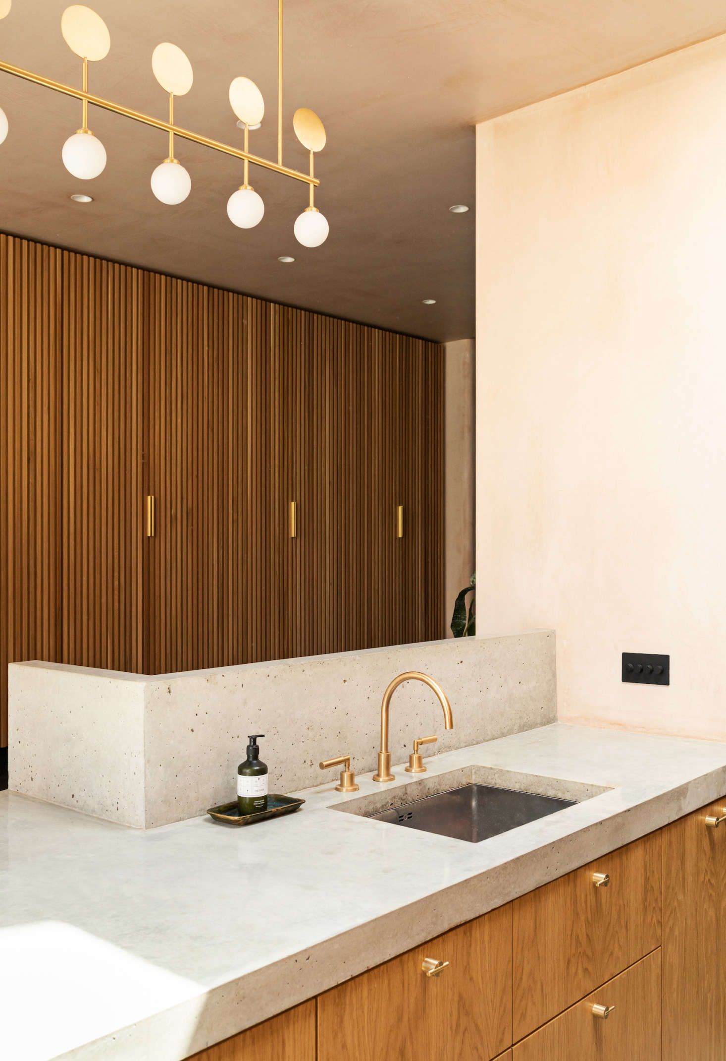 A glass and brass Atelier Areti Row Pendant Light is a glamorous touch.