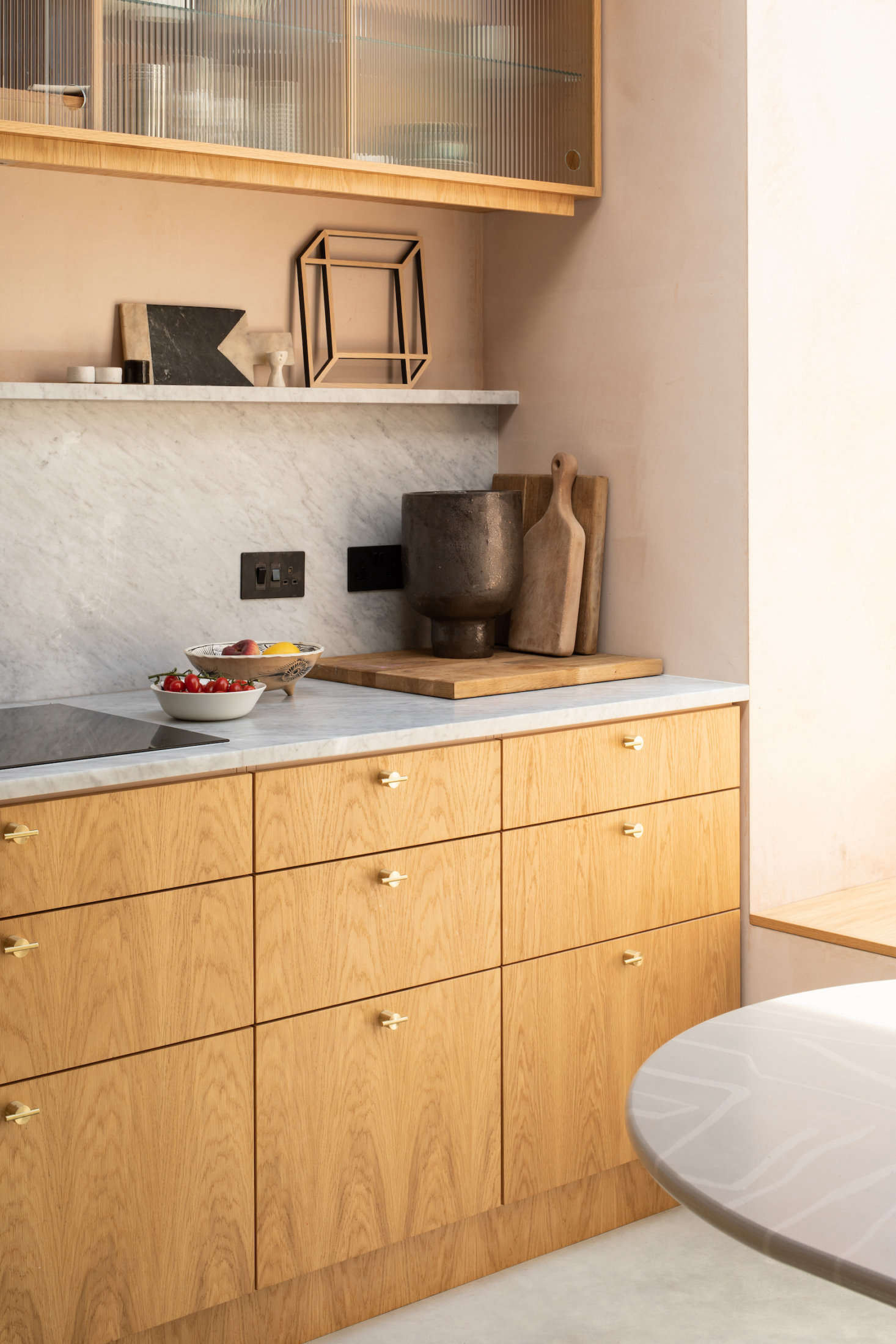 An above-the-counter narrow ledge and ridged-glass upper cabinets allow for partial open storage.