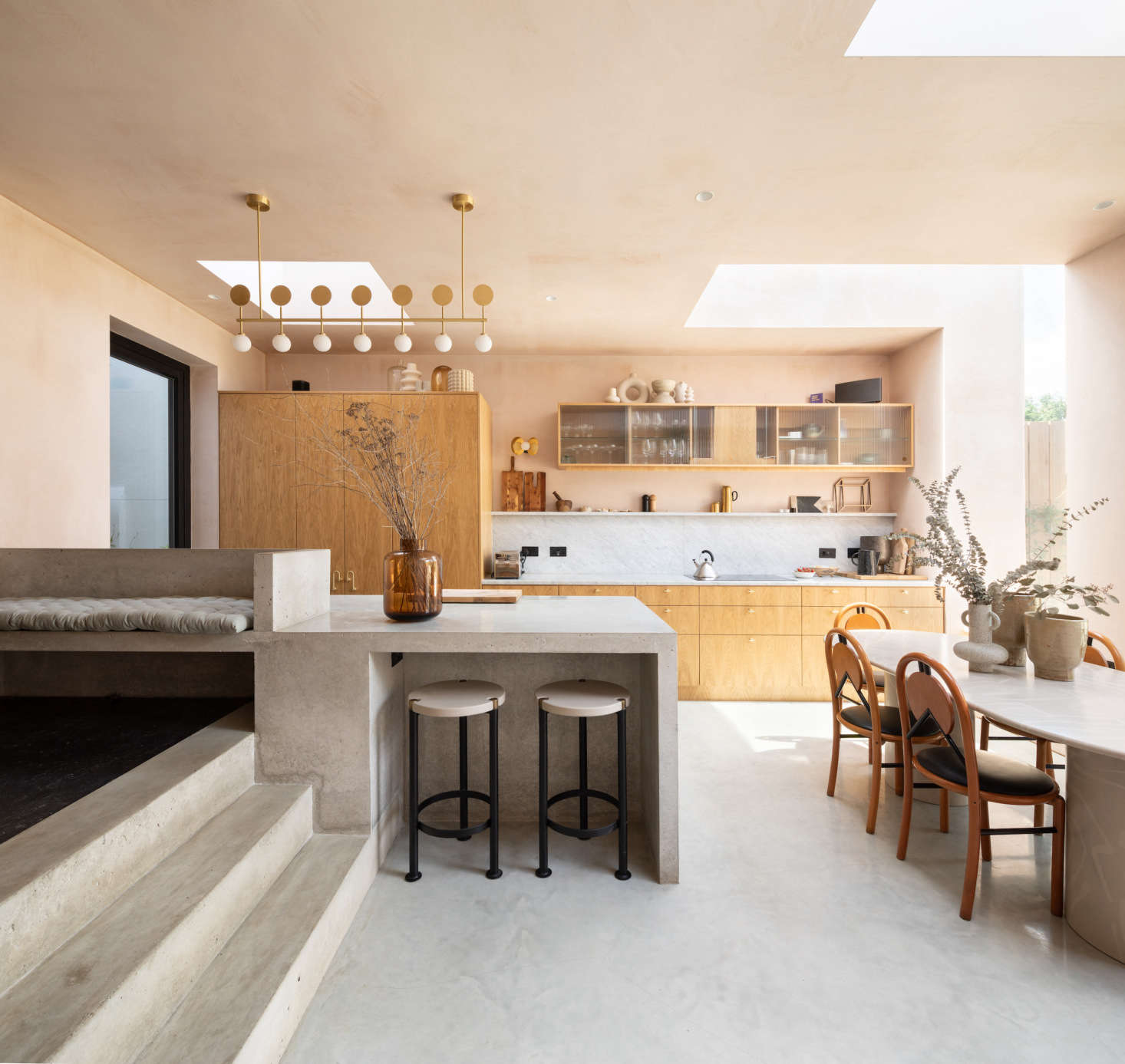 The kitchen and dining room are housed in the new rear extension of the home. To the left (just beyond the glass door) is the small courtyard (or tsubo-niwa) 