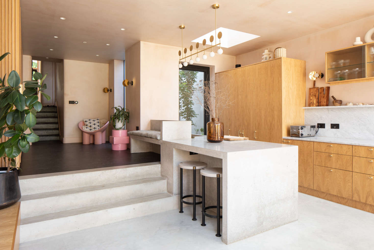 A built-in bench in the lofted area cleverly transitions into a kitchen peninsula.