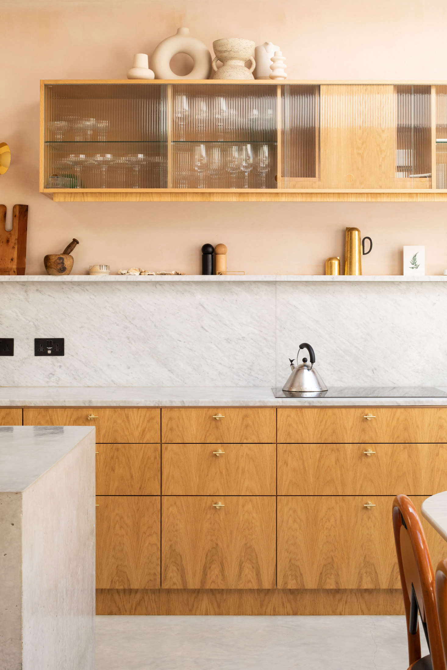 The cabinets were custom-made by the joinery experts at Oblique Furniture in London. The marble used for the countertop and backsplash was sourced from J&R Marble.